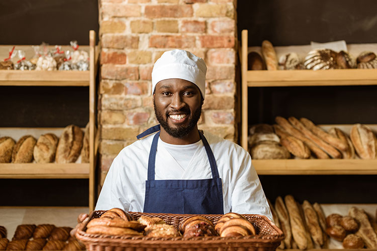 smiling-african-american-baker-holding-basket-